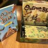 Outrun the bear open box with rulebook stood alongside.