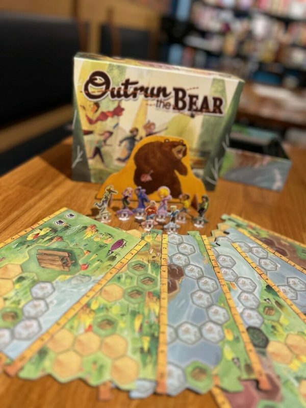 A game setup with reversible tiles fanned out on a table.
